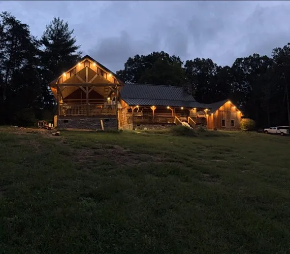 Log home with porch lights glowing at night