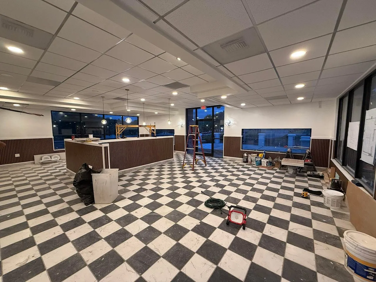 Commercial dining room with recessed ceiling lights and pendant lights